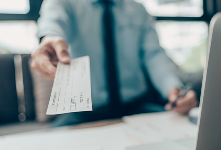 Man offering a check with savings